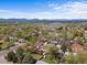 An aerial shot showcases a neighborhood with mountain views under a picturesque sky at 1650 Bedivere Cir, Lafayette, CO 80026