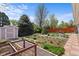 Backyard featuring lush landscaping, a garden, and a storage shed at 1650 Bedivere Cir, Lafayette, CO 80026