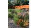A tranquil backyard featuring a picnic table with lush plants and a wooden fence at 1650 Bedivere Cir, Lafayette, CO 80026