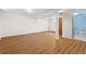 Spacious basement featuring wood floors, white walls and door that leads to bathroom at 1650 Bedivere Cir, Lafayette, CO 80026