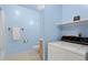 Clean bathroom with pale blue walls and a washing machine and dryer at 1650 Bedivere Cir, Lafayette, CO 80026