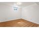 This bedroom has wood floors and a small window for natural light at 1650 Bedivere Cir, Lafayette, CO 80026
