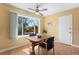 Dining area with hardwood floors, ceiling fan, and a large window overlooking the backyard at 1650 Bedivere Cir, Lafayette, CO 80026
