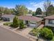Charming home featuring a well-manicured front yard with lovely greenery and a driveway leading to a garage at 1650 Bedivere Cir, Lafayette, CO 80026