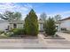 Inviting home with landscaped front yard, green shrubbery and mature trees offering curb appeal at 1650 Bedivere Cir, Lafayette, CO 80026