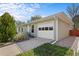 Side view of the property showcasing a well-maintained one-car garage with a white door at 1650 Bedivere Cir, Lafayette, CO 80026
