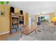 Inviting living room featuring hardwood floors, a ceiling fan, and built-in shelving at 1650 Bedivere Cir, Lafayette, CO 80026