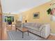 Inviting living room featuring hardwood floors, a ceiling fan, and large windows for ample natural light at 1650 Bedivere Cir, Lafayette, CO 80026