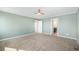 Spacious bedroom with neutral carpet, ceiling fan, and ensuite bathroom access at 21383 E Smoky Hill Rd, Centennial, CO 80015