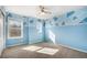 Bright bedroom featuring blue walls and a ceiling fan for added comfort at 21383 E Smoky Hill Rd, Centennial, CO 80015