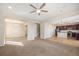 Open floor plan with carpeted living room, staircase, and hardwood kitchen with dark cabinetry at 21383 E Smoky Hill Rd, Centennial, CO 80015