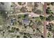 Wide aerial view of rural acreage, multiple structures, parking area, and surrounding native vegetation at 7715 Rafter Rd, Franktown, CO 80116
