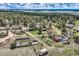 Spacious aerial view of a home and property, featuring lush trees and serene natural surroundings in a quiet area at 7715 Rafter Rd, Franktown, CO 80116