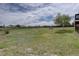 Expansive backyard with lush grass, mature trees, and partial fencing at 34544 Columbine W Trl, Elizabeth, CO 80107