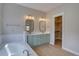 Bathroom boasts double vanity with green cabinets, white countertops, and a walk-in closet at 34544 Columbine W Trl, Elizabeth, CO 80107