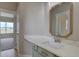 Bathroom offers a large mirror, quartz countertops, and custom green cabinets at 34544 Columbine W Trl, Elizabeth, CO 80107