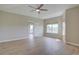 Airy primary bedroom with ceiling fan, natural light, and access to private balcony at 34544 Columbine W Trl, Elizabeth, CO 80107
