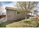 Rear exterior view showcases siding, yard, and patio at 9640 Sydney Ln, Highlands Ranch, CO 80130