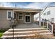 Covered back patio with stairs down to a backyard oasis with space to entertain at 9640 Sydney Ln, Highlands Ranch, CO 80130