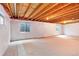 Unfinished basement space with egress windows allowing natural light at 9640 Sydney Ln, Highlands Ranch, CO 80130