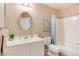 Bright bathroom featuring an oval mirror, a sink with vanity, and a shower-tub combo at 9640 Sydney Ln, Highlands Ranch, CO 80130
