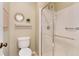 Bright bathroom featuring a glass enclosed shower, bright paint, and large mirror at 9640 Sydney Ln, Highlands Ranch, CO 80130