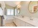 Bright bathroom boasting a large countertop, double sinks, and large tub at 9640 Sydney Ln, Highlands Ranch, CO 80130