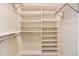 Spacious closet with ample shelving and metal bars for hanging clothes at 9640 Sydney Ln, Highlands Ranch, CO 80130