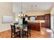 Open dining area adjacent to kitchen boasts a glass table set and seamless access to the backyard at 9640 Sydney Ln, Highlands Ranch, CO 80130