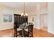 Bright dining room showcases updated lighting fixtures, ample windows, and hardwood flooring at 9640 Sydney Ln, Highlands Ranch, CO 80130