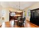 Bright dining area featuring wood floors and a glass table, perfect for Gathering meals at 9640 Sydney Ln, Highlands Ranch, CO 80130