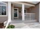 Inviting front porch with white columns and decorative wreath, perfect for relaxing at 9640 Sydney Ln, Highlands Ranch, CO 80130