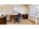 Home office featuring a wooden desk, comfortable chair, and neutral-toned walls at 9640 Sydney Ln, Highlands Ranch, CO 80130