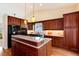 Modern kitchen featuring granite countertops, stainless steel appliances, and ample cherry wood cabinetry at 9640 Sydney Ln, Highlands Ranch, CO 80130