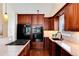 Gourmet kitchen with custom cabinets, stainless steel appliances, and granite countertops at 9640 Sydney Ln, Highlands Ranch, CO 80130
