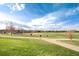 Community park featuring walking trails, baseball field, and open green space for activities at 9640 Sydney Ln, Highlands Ranch, CO 80130