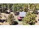 Aerial view of the home nestled in trees, featuring outdoor living space on large deck and a peaceful retreat at 32187 Sylvan Rd, Golden, CO 80403