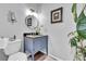 Stylish powder room with a blue vanity, modern lighting, and tasteful decor at 32187 Sylvan Rd, Golden, CO 80403