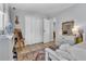 Bright bedroom featuring white trim, a mirrored dresser, and natural light at 32187 Sylvan Rd, Golden, CO 80403