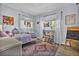 Bright bedroom with two windows, hardwood floors and colorful accents at 32187 Sylvan Rd, Golden, CO 80403