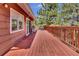 Spacious wooden deck with ample seating, perfect for outdoor dining and entertaining at 32187 Sylvan Rd, Golden, CO 80403