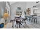 Cozy dining area features natural light, wood floors, and views into the kitchen for entertaining at 32187 Sylvan Rd, Golden, CO 80403