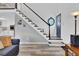 Inviting entryway with stylish staircase, modern flooring, and a glimpse of the kitchen at 32187 Sylvan Rd, Golden, CO 80403