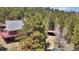Charming cabin-style home with a large deck, carport and surrounded by lush trees and natural beauty at 32187 Sylvan Rd, Golden, CO 80403
