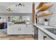 Bright kitchen with marble countertops, wooden shelves, stylish backsplash and lots of natural light at 32187 Sylvan Rd, Golden, CO 80403