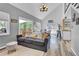 Inviting living room with natural light, vaulted ceilings, wood floors, and access to the outdoor deck at 32187 Sylvan Rd, Golden, CO 80403