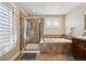 Luxurious bathroom featuring a tiled shower, soaking tub, and elegant finishes for a spa-like experience at 8720 E 29Th Ave, Denver, CO 80238