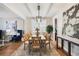 Bright dining room featuring a modern light fixture, stylish decor, and hardwood floors at 8720 E 29Th Ave, Denver, CO 80238