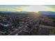 Panoramic aerial view of a residential community at sunset, showcasing mountain views at 1721 Wingfeather Ln, Castle Rock, CO 80108