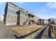 Exterior of home with dry grass, stone accents, wood fence, and walkout deck at 1721 Wingfeather Ln, Castle Rock, CO 80108